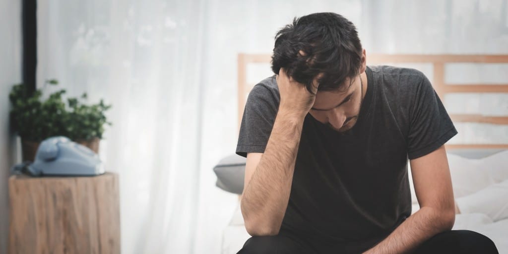 Image of a man feeling guilt after placing father in adult care. Find help for guilt at MindSol Wellness Center in Sarasota, Florida