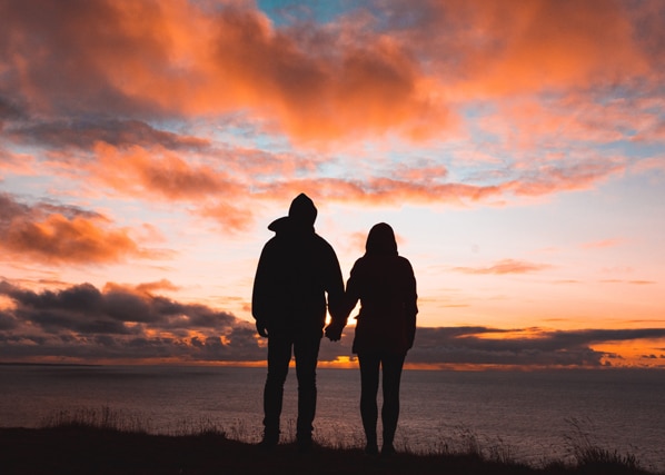 Couple holding hands and looking at the sunset after a marriage counseling session at MindSol Wellness Center in Sarasota, Florida
