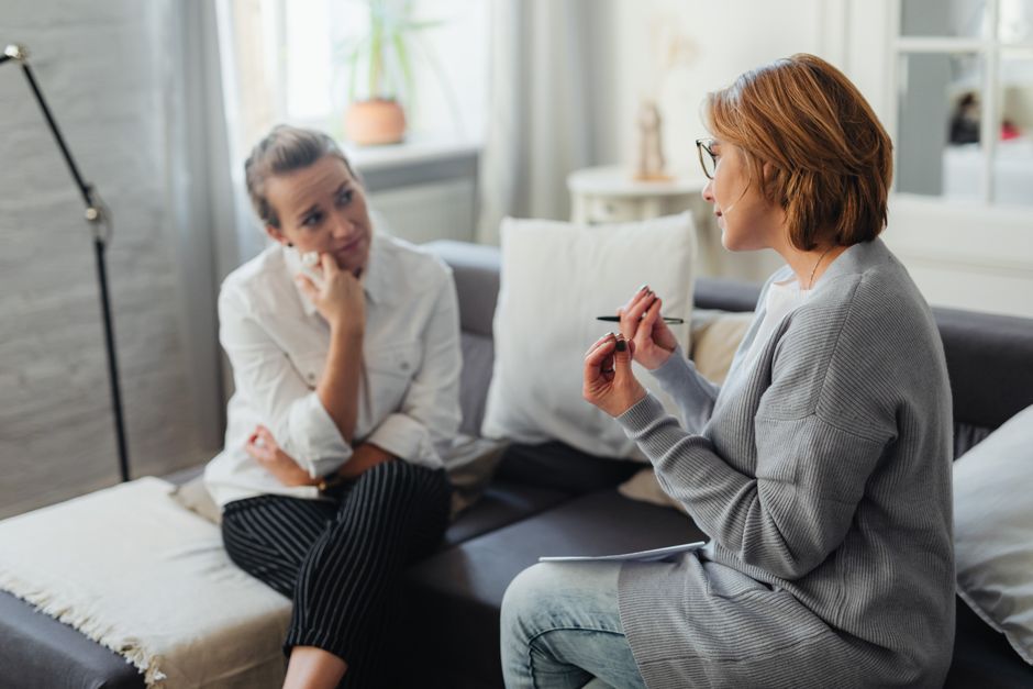 A therapist and client in a supportive, private conversation