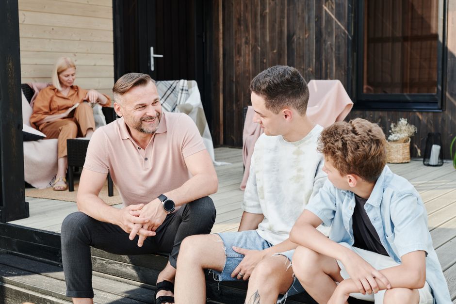 A family talking and smiling together outdoors