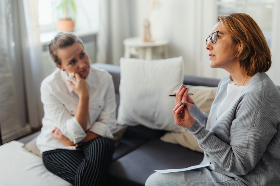 Two people in a calm, private counseling session in a comfortable office